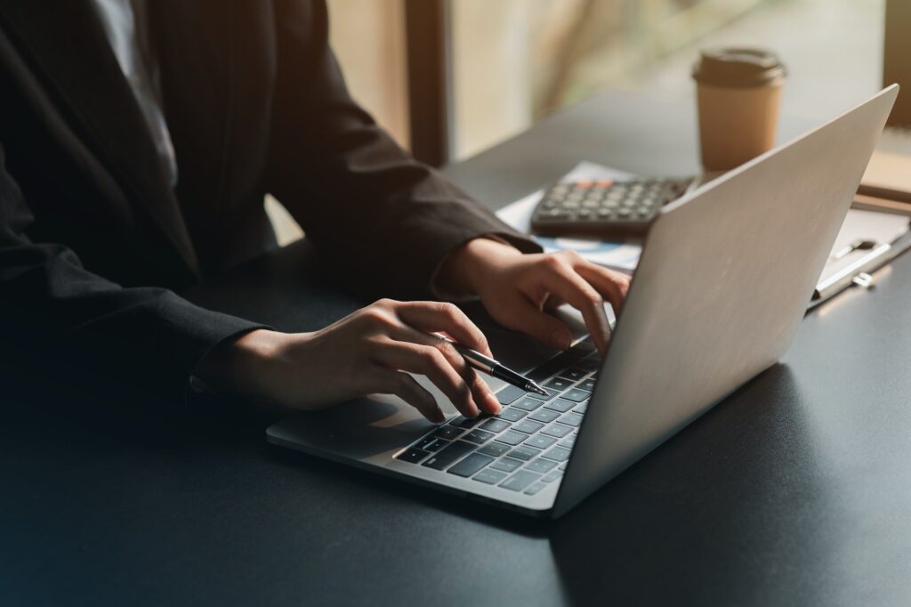 Close-up of hands resting on keyboard to view financial data.