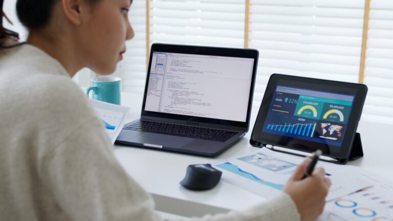 Back rear view of young asian woman, freelance data scientist work remotely at home